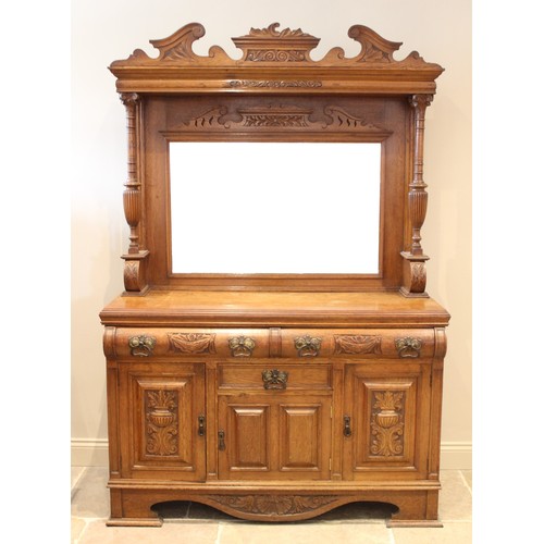 666 - A late Victorian carved oak mirror back sideboard, the high mirror back supported on a pair of carve... 