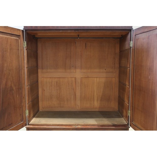 659 - An early 19th century mahogany linen press, with a cavetto cornice above a pair of invert panelled c... 