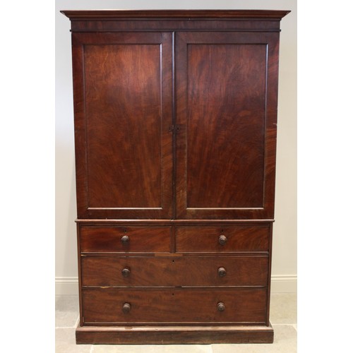 659 - An early 19th century mahogany linen press, with a cavetto cornice above a pair of invert panelled c... 