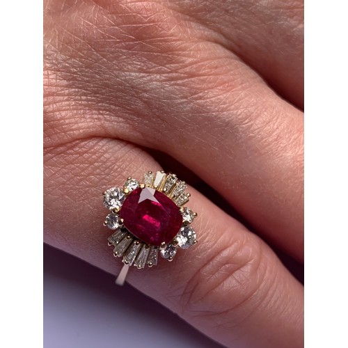 166 - A ruby and diamond cluster ring, the central rectangular cushion cut ruby (measuring 8.2 x 6.6 x 4.0... 