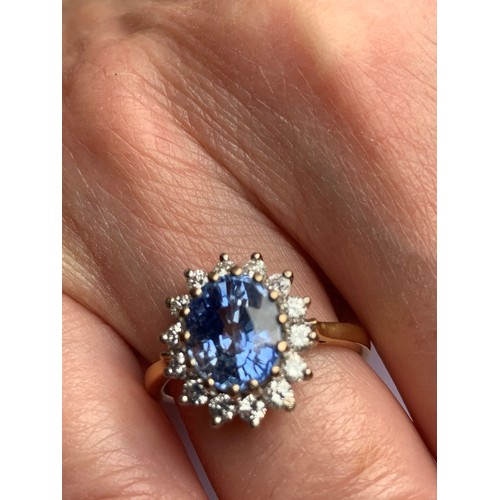 167 - A sapphire and diamond cluster ring, the central oval mixed cut sapphire (measuring approximately 9.... 