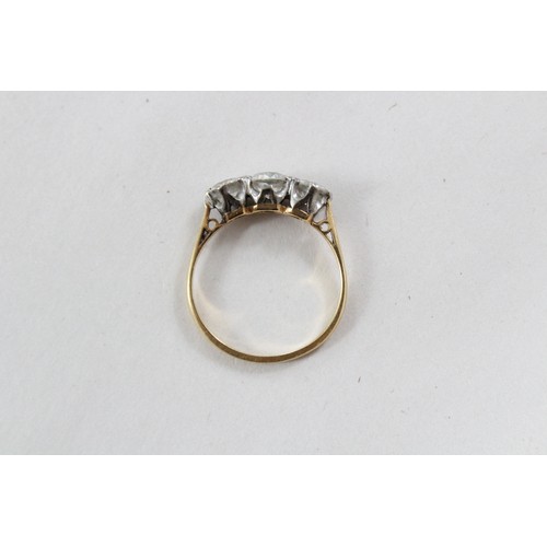 119 - A diamond three stone ring, comprising a central round brilliant cut diamond (weighing approximately... 