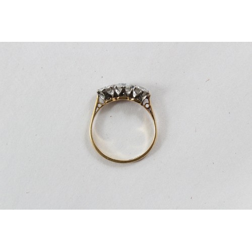 119 - A diamond three stone ring, comprising a central round brilliant cut diamond (weighing approximately... 