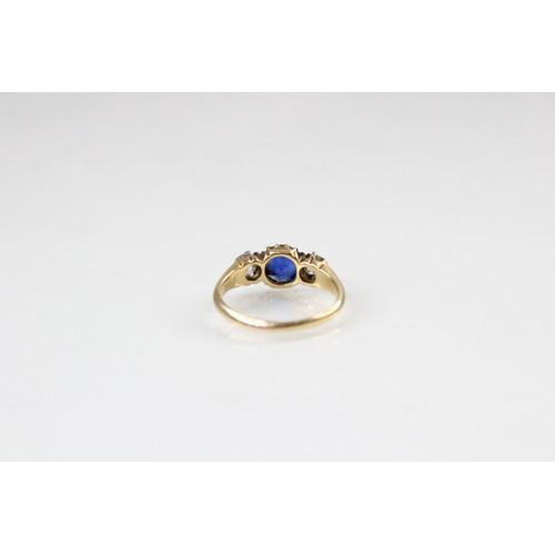 89 - An Edwardian sapphire and diamond three stone ring, comprising a round mixed cut sapphire measuring ... 