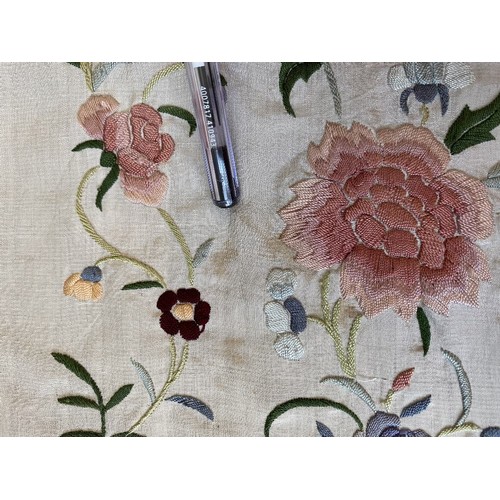 402 - A Chinese polychrome florally decorated machine embroidered silk piano shawl, against a cream ground... 