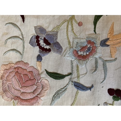 402 - A Chinese polychrome florally decorated machine embroidered silk piano shawl, against a cream ground... 