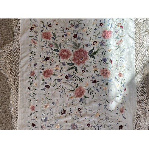 402 - A Chinese polychrome florally decorated machine embroidered silk piano shawl, against a cream ground... 