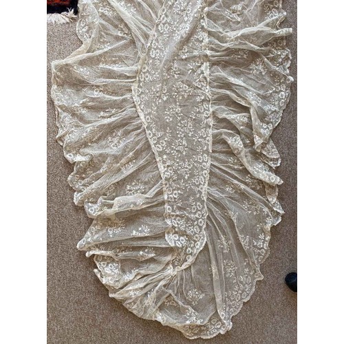 404 - An early 19th century Ayrshire work bodice, the unusual bodice with lace edged lobed bustle and foli... 