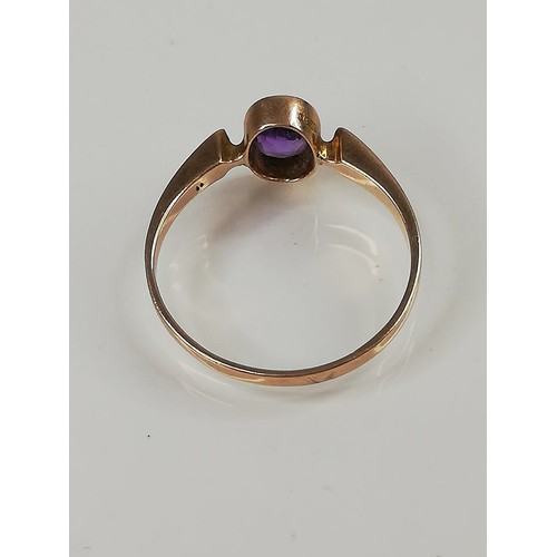 162 - A late Edwardian amethyst set 9ct gold ring, the central oval mixed cut amethyst (measuring 6.5mm x ... 