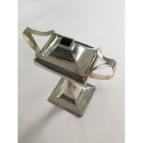 62 - A George V silver table lighter by Charles Boyton & Son Ltd, London 1912, of faceted form on tapered... 