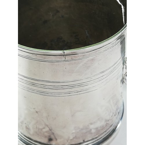 23 - A Queen Anne silver mug, of tapered cylindrical form on raised circular foot with simple loop handle... 