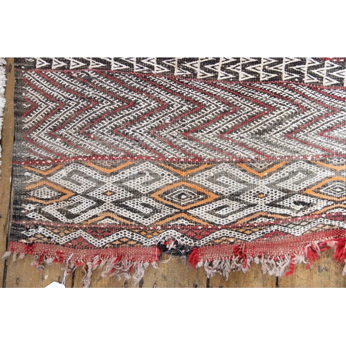 387A - A Berber tribe, North African, Moroccan wool carpet, with geometric bands in red, black and white co... 