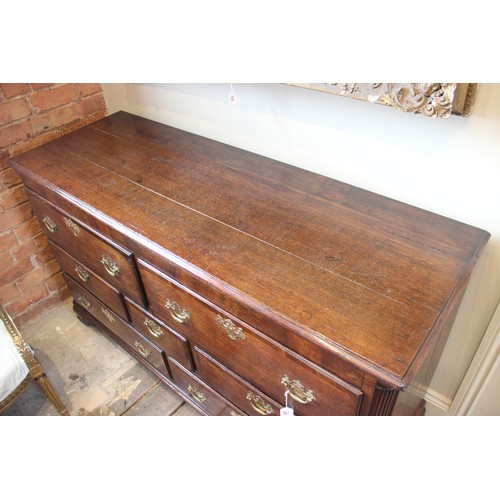 629 - A George III oak and mahogany cross banded dresser base, possibly converted from a Lancashire mule c... 