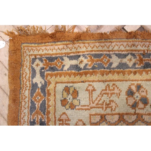 389 - A large Turkish wool carpet, in orange and cream colourways with a larger central medallion, 406cm x... 