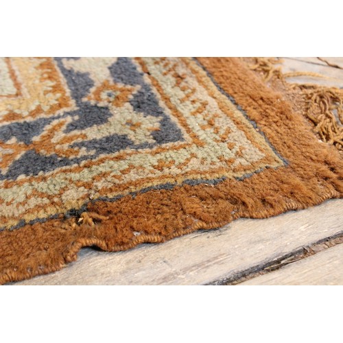 389 - A large Turkish wool carpet, in orange and cream colourways with a larger central medallion, 406cm x... 