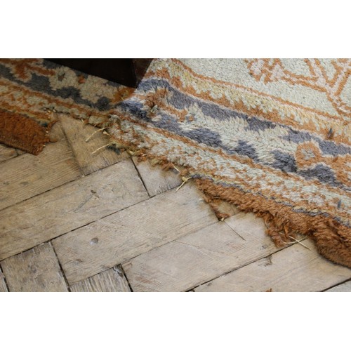 389 - A large Turkish wool carpet, in orange and cream colourways with a larger central medallion, 406cm x... 