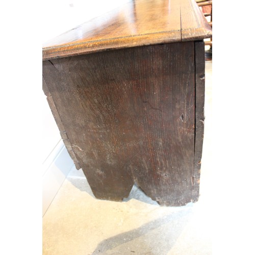 608 - An early eighteenth century oak six plank coffer, the rectangular moulded top opening to an integrat... 