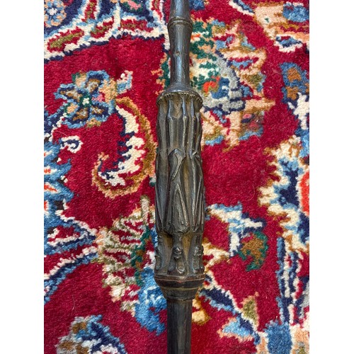 300 - A Naga Tribe spear, 19th century, with barbed iron terminal and carved figural shaft with dyed feath... 