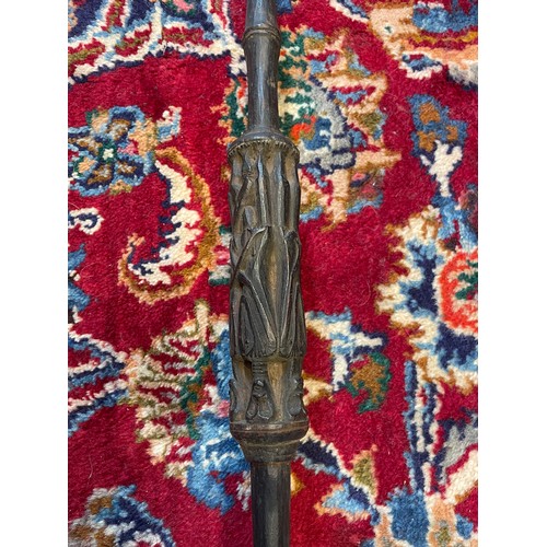 300 - A Naga Tribe spear, 19th century, with barbed iron terminal and carved figural shaft with dyed feath... 