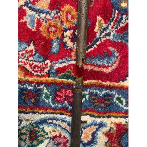 300 - A Naga Tribe spear, 19th century, with barbed iron terminal and carved figural shaft with dyed feath... 