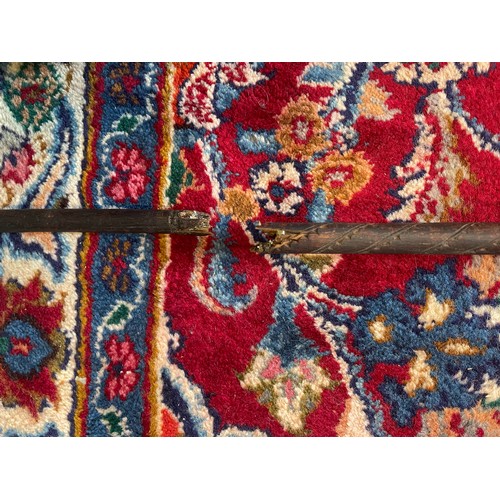 300 - A Naga Tribe spear, 19th century, with barbed iron terminal and carved figural shaft with dyed feath... 