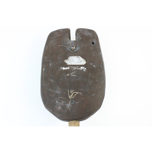 312 - A collection of Tribal carvings, predominantly from East Africa, to include a carved panel, 36cm x 3... 