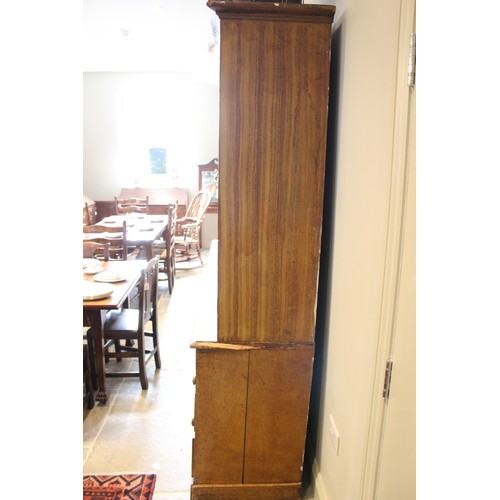 705 - A Victorian scumbled pine housekeepers cupboard, the moulded cornice above four invert panelled cupb... 