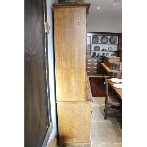 705 - A Victorian scumbled pine housekeepers cupboard, the moulded cornice above four invert panelled cupb... 