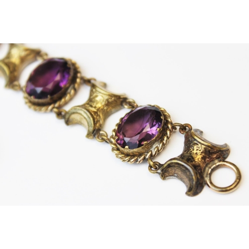 101 - A Victorian style paste set bracelet, comprising four oval mixed cut purple paste, each measuring 16... 