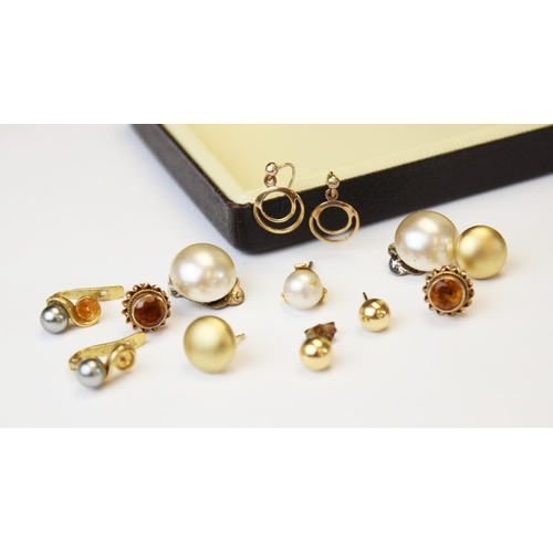 102 - A pair of citrine set 9ct gold earrings, each comprising a central round mixed cut citrine measuring... 