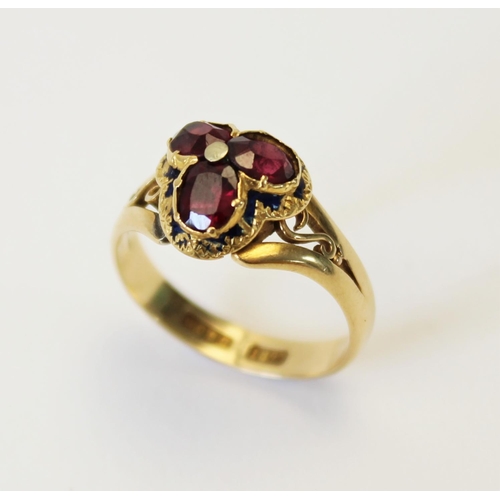 106 - A Victorian garnet and enamel 18ct gold ring, the trefoil shaped head set with three oval old cut ga... 