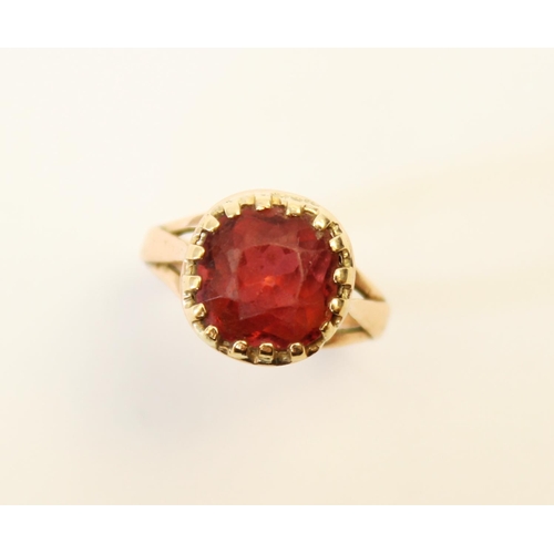 107 - A tourmaline ring, the central orange-pink cushion cut tourmaline (measuring 8.8mm x 8.9mm), claw se... 