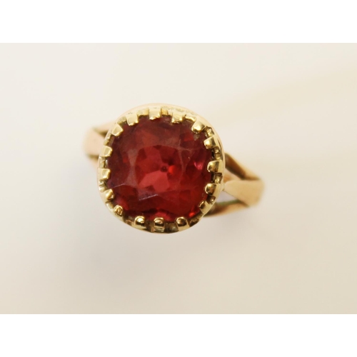 107 - A tourmaline ring, the central orange-pink cushion cut tourmaline (measuring 8.8mm x 8.9mm), claw se... 