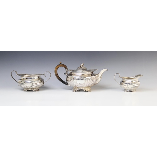 11 - A George III silver three piece tea service by Joseph Angell I, London 1815, comprising teapot, milk... 