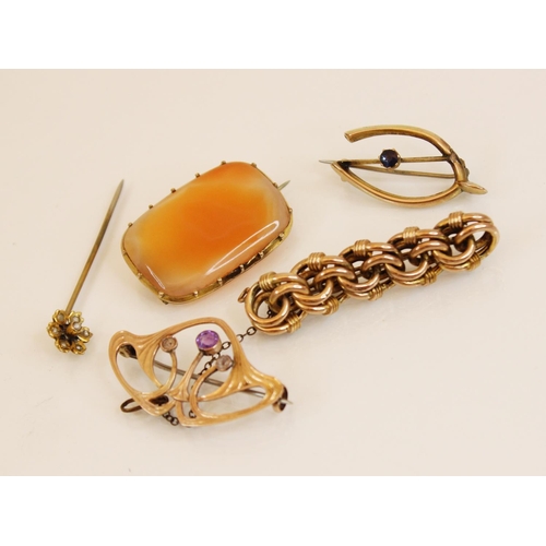 115 - A yellow metal amethyst set Art Nouveau brooch, in the manner of Archibald Knox for Liberty, 3.7cm w... 