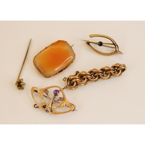 115 - A yellow metal amethyst set Art Nouveau brooch, in the manner of Archibald Knox for Liberty, 3.7cm w... 