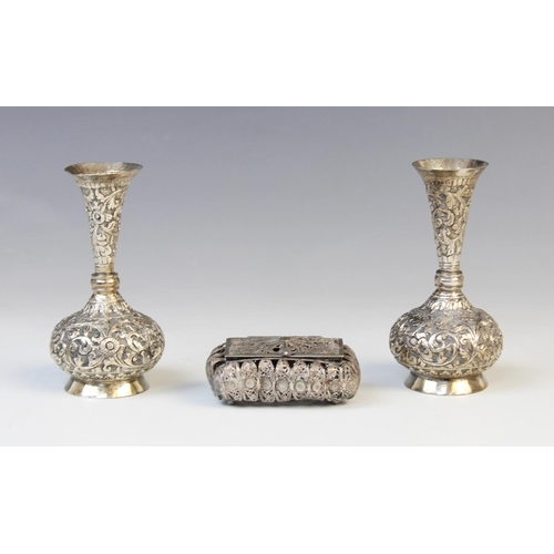 13 - A pair of Burmese white metal posy vases, each with compressed circular bodies with tapering necks a... 