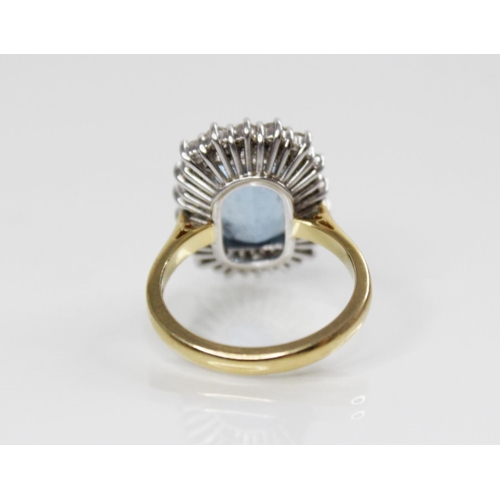 141 - An aquamarine and diamond 18ct gold cluster ring, the central rectangular mixed cut aquamarine (meas... 