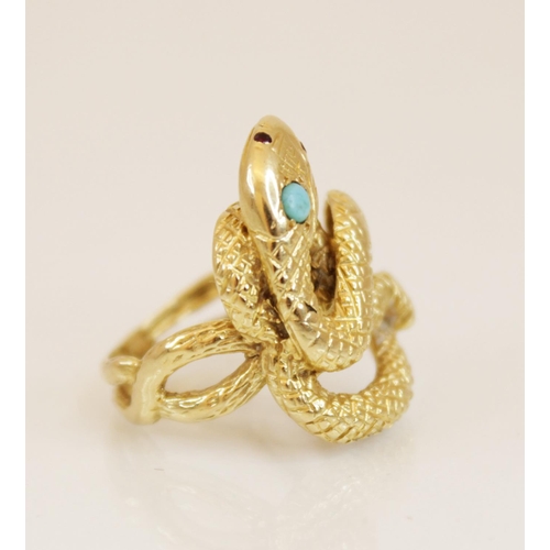 150 - A continental 18ct gold turquoise and ruby set snake ring, the coiled body with engraved decoration,... 