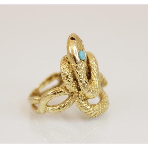 150 - A continental 18ct gold turquoise and ruby set snake ring, the coiled body with engraved decoration,... 