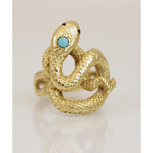 150 - A continental 18ct gold turquoise and ruby set snake ring, the coiled body with engraved decoration,... 