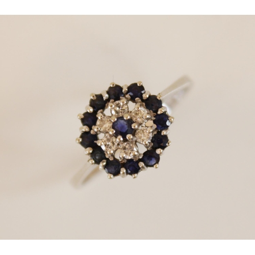 154 - An 18ct gold sapphire and diamond floral cluster ring, comprising six round brilliant cut diamonds a... 