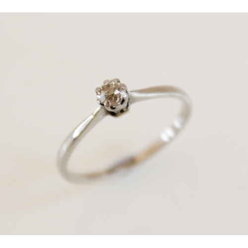 166 - A diamond solitaire ring, comprising a central round old cut diamond, 3.5mm wide, claw set in white ... 