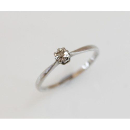 166 - A diamond solitaire ring, comprising a central round old cut diamond, 3.5mm wide, claw set in white ... 