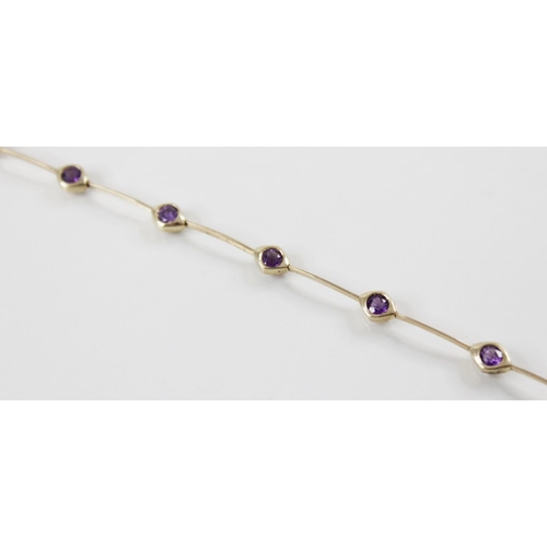 171 - An amethyst set 14ct gold line bracelet, the articulated knife-edge bar link bracelet interspersed b... 