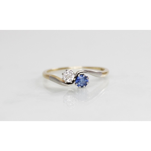 194 - A diamond and sapphire two-stone ring, comprising a round mixed cut diamond (measuring 3.5mm diamete... 