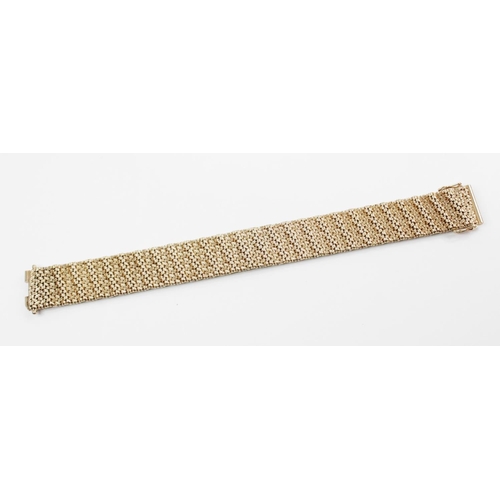 197 - A 9ct integral-link bracelet, the textured woven-link strap with sliding clasp and safety fittings, ... 