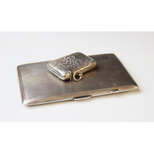 21 - A George V silver cigarette case by E.J. Houlston, Birmingham 1919, of rectangular form with engine ... 