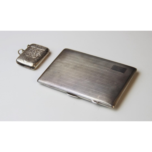 21 - A George V silver cigarette case by E.J. Houlston, Birmingham 1919, of rectangular form with engine ... 