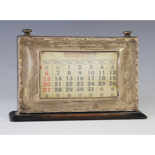 3 - A George V silver mounted desk calendar, Birmingham 1924, the rectangular aperture displaying days a... 